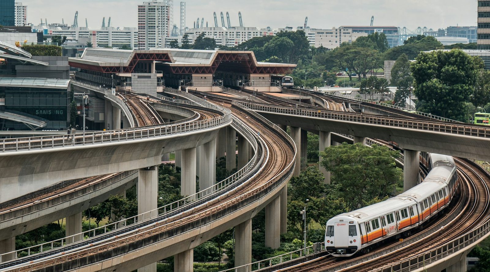 Elevated Singapore MRT train rounding a curved viaduct